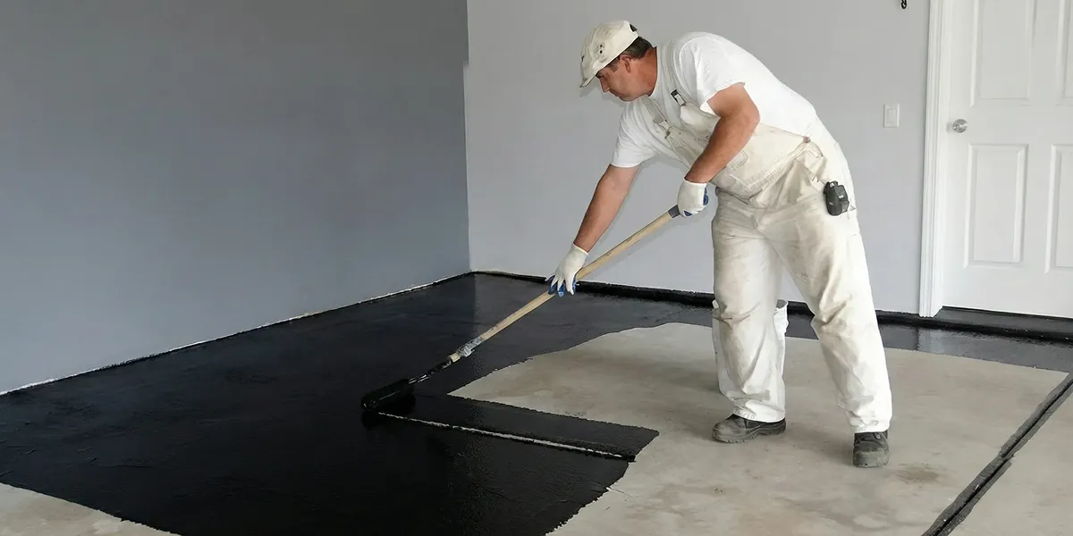 basement waterproofing professional applying waterproof coating to protect a basement floor in San Jose, CA