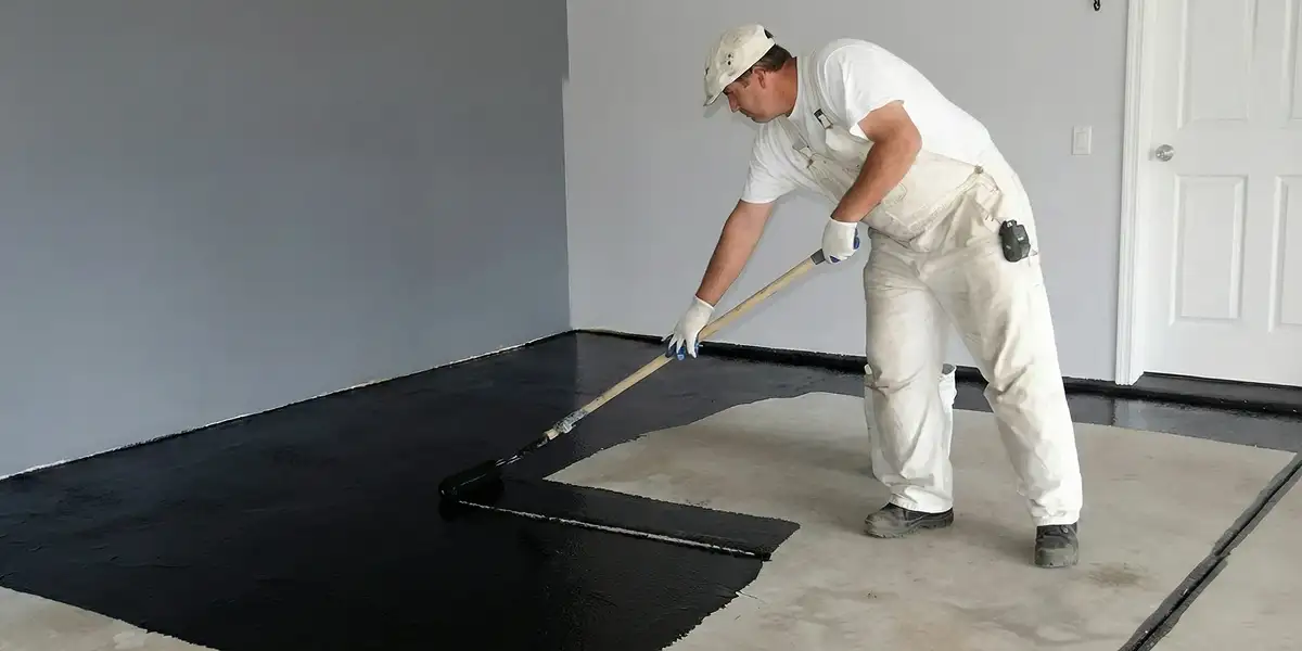 basement waterproofing professional applying waterproof coating to protect a basement floor in San Jose, CA