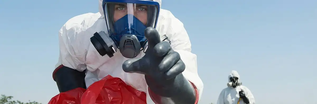 sewage clean up technician wearing protective gear handling biohazard materials in San Jose, CA
